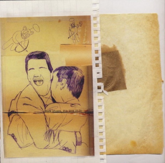 Booklet page: two men in suits embracing (UK CD, 2001)