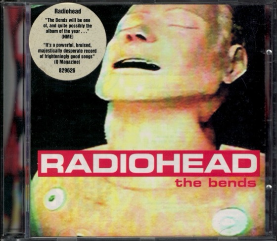 The UK CD in its wrapper, with the NME and Q review sticker (Parlophone, 1995)